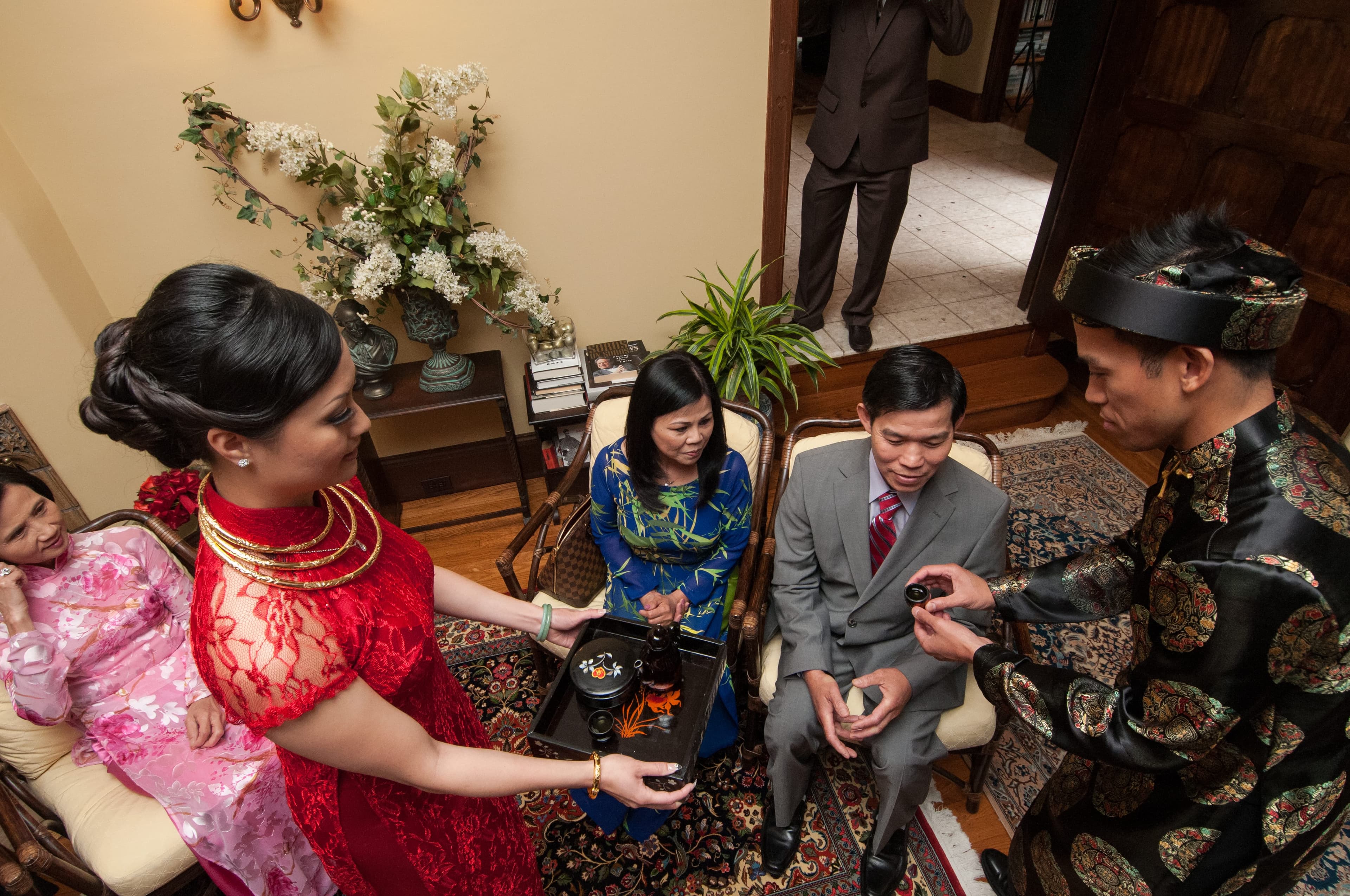 The bride serving tea to the groom's parents from a lacquered tea set